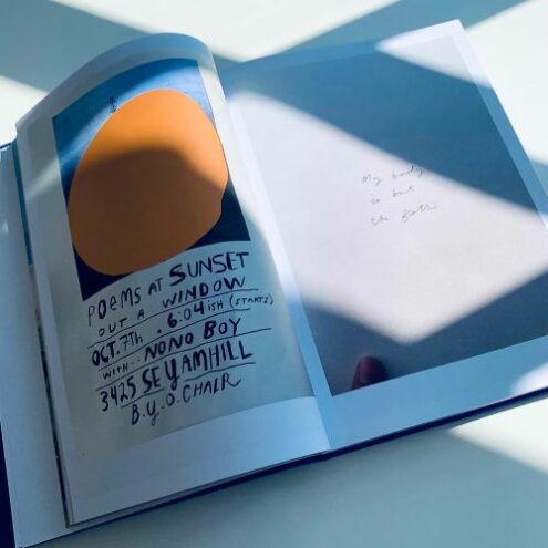 Photo of open coffee table book showing poetry by Anis Mojgani