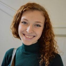 Shayla Bailey wearing a teal turtleneck sweater and smiling for the camera