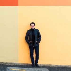 Jennifer Higdon standing in front of a yellow wall
