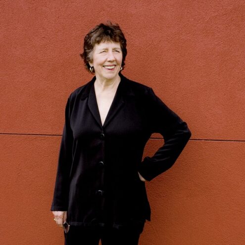Joan Tower standing in front of a red wall