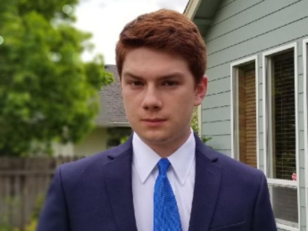 Connor Barrow standing outside in a suit