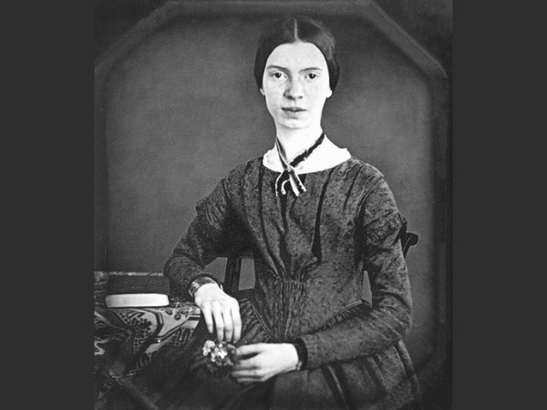 woman in grey dress sitting for a portrait